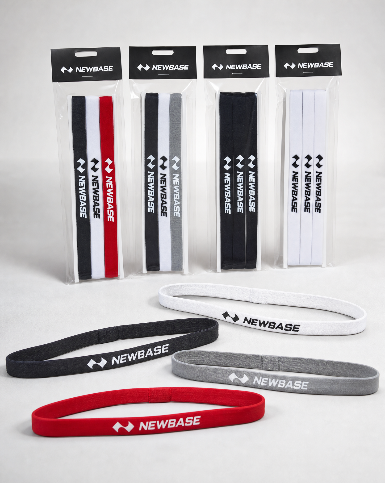 Newbase headbands in various colors with packaging on a white background